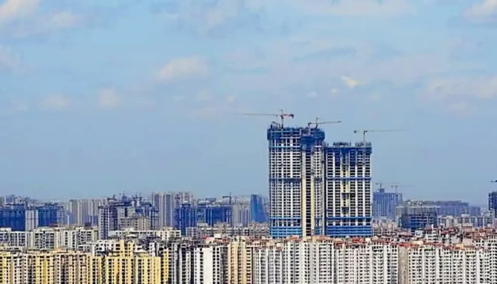 High-rise buildings and under-construction residential towers in Noida, representing ongoing real estate developments amid the new 6% stamp duty policy for property buyers