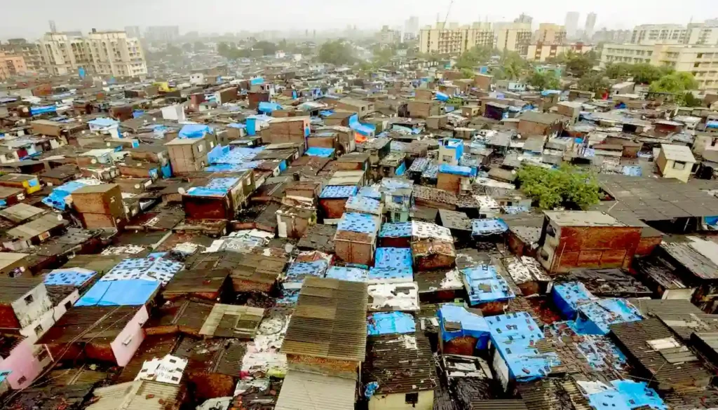 Aerial view of Dharavi slums in Mumbai, highlighting the dense structures and the area targeted for redevelopment using drones and LiDAR technology.