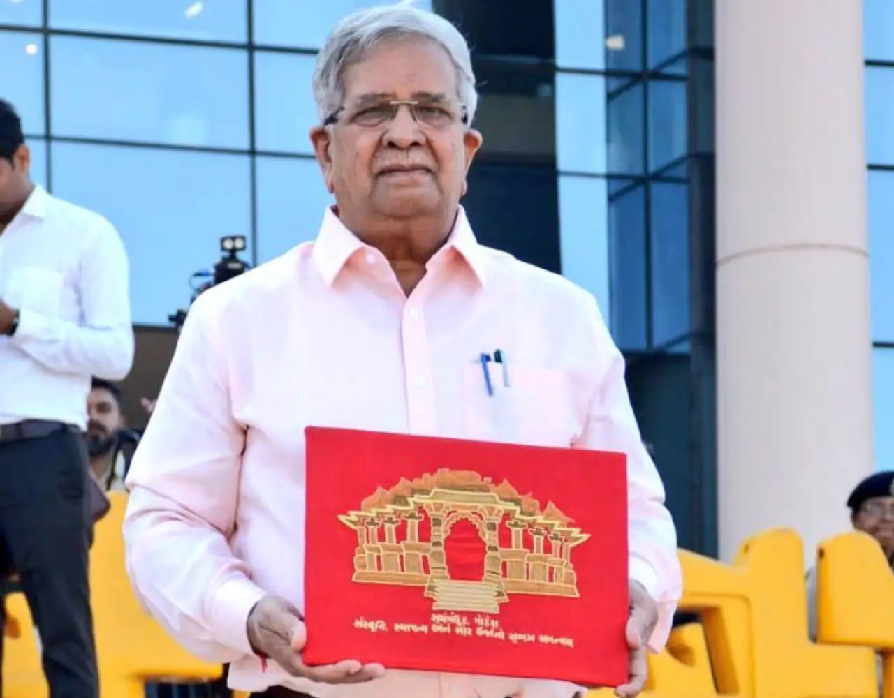 Gujarat Finance Minister Kanubhai Desai before presenting the 2025-26 state budget with a red budget briefcase outside the Gujarat Assembly.